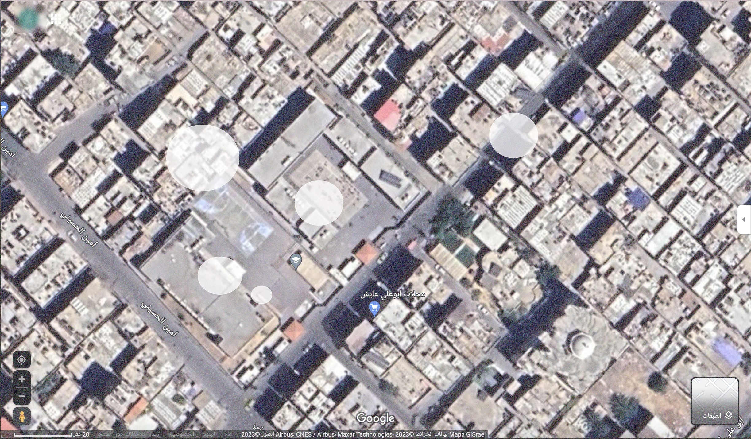 Screenshot of satellite imagery from Google Maps showing a school; white circles denoting where bombs could have fallen.